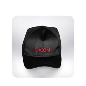 A black baseball cap with the word "MAXIM" embroidered in red across the front. The cap is centered in the frame, against a soft white background with rounded corners. The brim of the cap is a darker shade of black than the rest of the hat. The lighting is soft and diffused, giving the cap a slightly glossy appearance. It's difficult to ascertain any hair transplant procedure from this image.